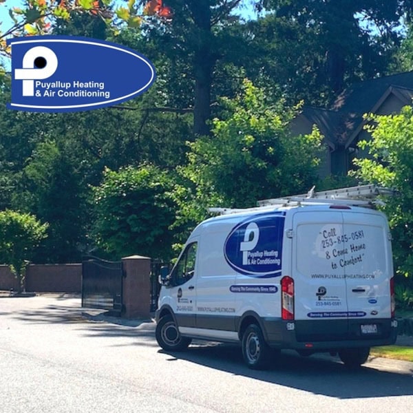 Puyallup HVAC truck driving down residential road.