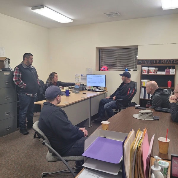 Puyallup HVAC technicians receiving a demo on commercial IAQ products.