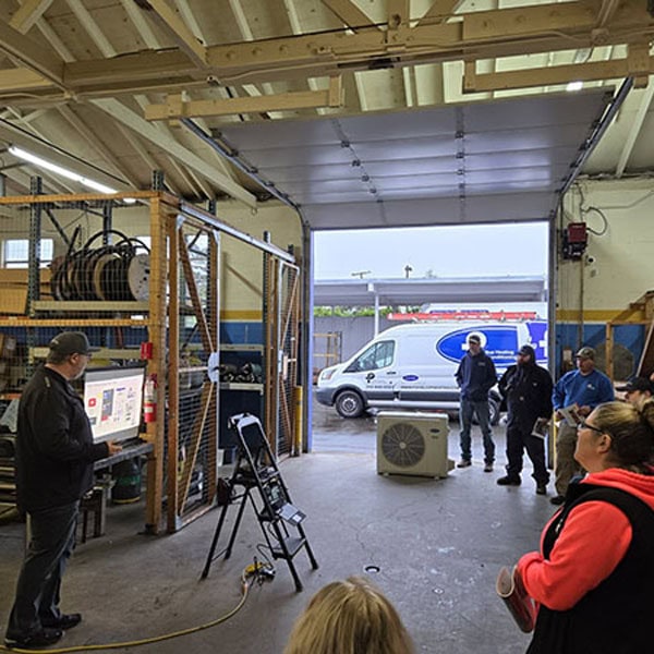 Puyallup team meeting inside of work warehouse.