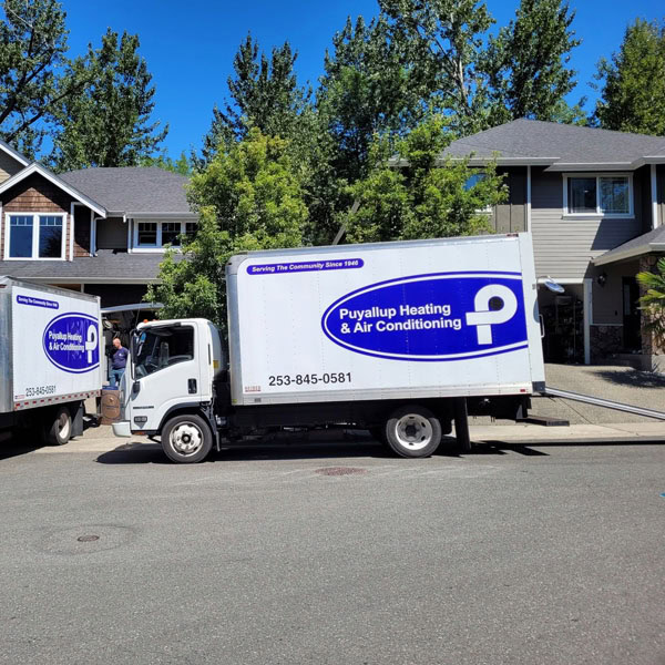 Puyallup HVAC branded truck in parking lot outside of residential job site.