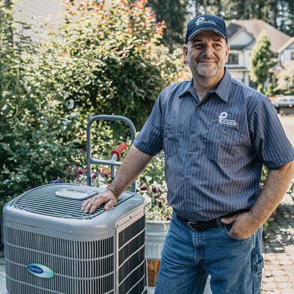 Puyallup technician outside home with AC unit.