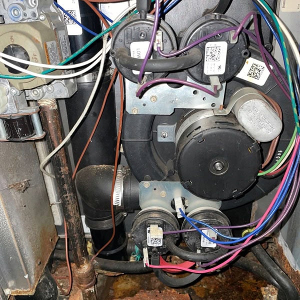 Gas furnace that is completely rusted through, in need of repairs.