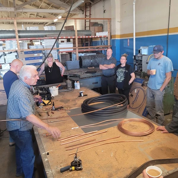 Puyallup team receiving a demo in their warehouse before new construction job site.