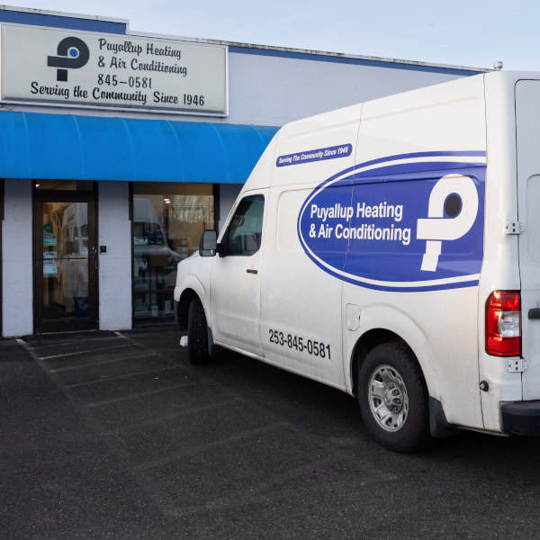 Puyallup Heating & Air Conditioning branded work truck in parking lot.