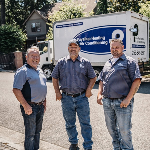 Puyallup Heating & Air Conditioning HVAC installation and repair experts outside Calgary home.
